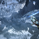 The view from underneath Horizon Forbidden West with Aloy gliding beneath the mountains.